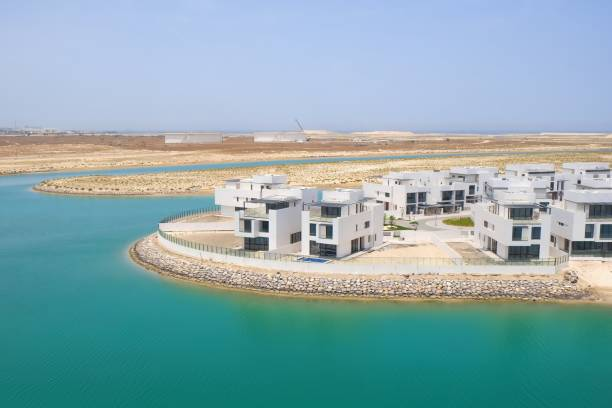 Modern waterfront villas in Dubai showcasing luxury living amidst serene water views.