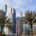 Modern high-rise buildings and palm trees in a typical real estate zone of Dubai showcasing the cityscape.