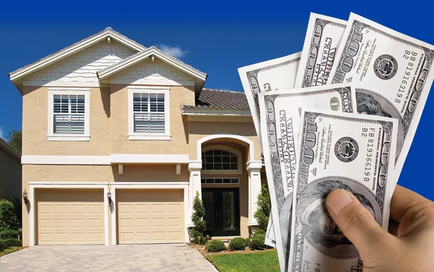 A hand holding a stack of 100-dollar bills in front of a large two-story house with a three-car garage.